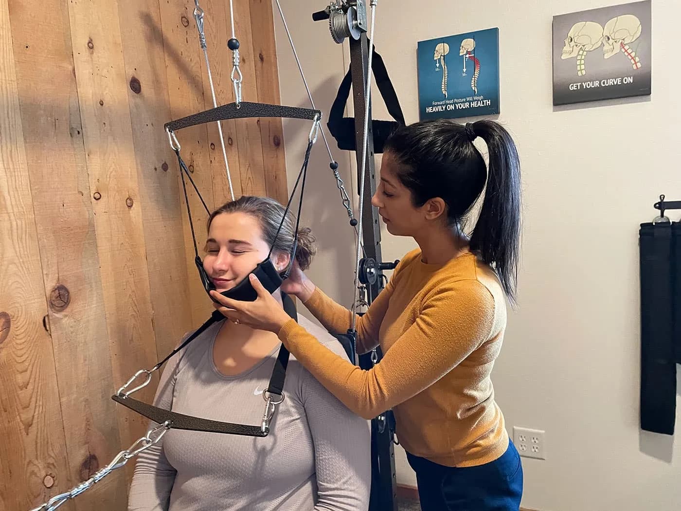 Young woman receiving whiplash treatment at Elevation Spine Center
